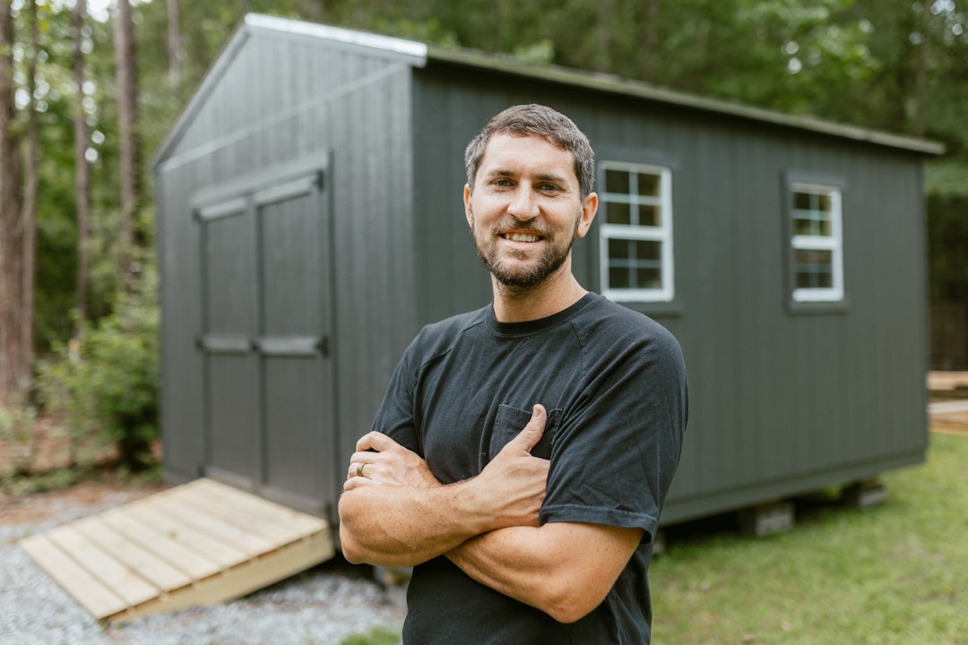 Photo of Chris Gary in front of his shed.